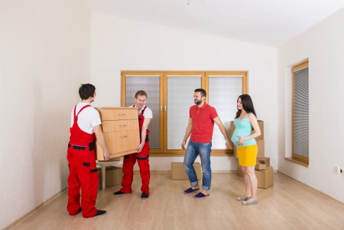 Furniture and household items being loaded into a moving truck in Camden